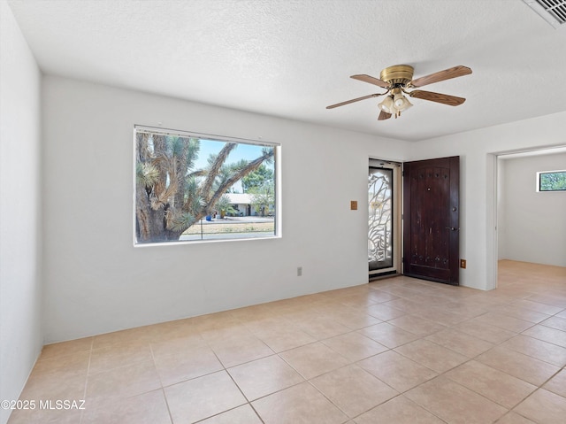 2638 N Wilson Ave, Tucson, AZ 85719 - entryway featuring ceiling fan, light tile patterned floors, and a textured ceiling