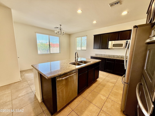 8361 N Mountain Stone Pine Way, Tucson, AZ 85743 - kitchen featuring stainless steel appliances, a center island with sink, a chandelier, light tile patterned floors, and recessed lighting