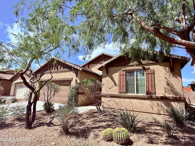 8361 N Mountain Stone Pine Way, Tucson, AZ 85743 - view of side of property with stucco siding, a garage, and concrete driveway