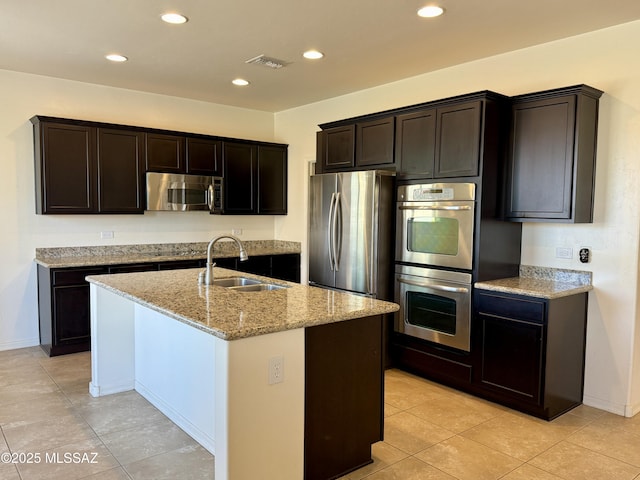8361 N Mountain Stone Pine Way, Tucson, AZ 85743 - kitchen featuring stainless steel appliances, light stone countertops, a kitchen island with sink, recessed lighting, and light tile patterned flooring