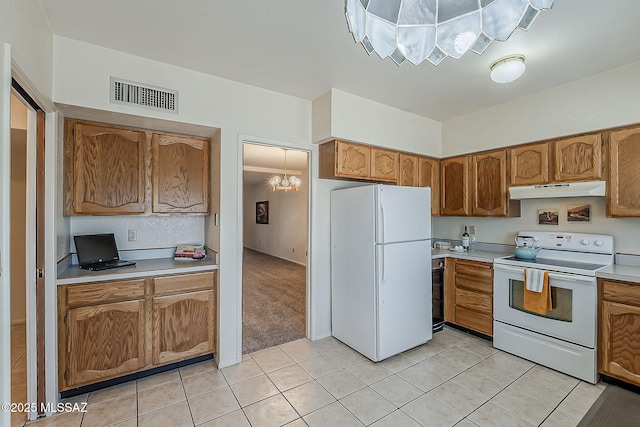 9453 E Calle Bolivar, Tucson, AZ 85715 - kitchen with white appliances, under cabinet range hood, light countertops, light tile patterned floors, and brown cabinetry