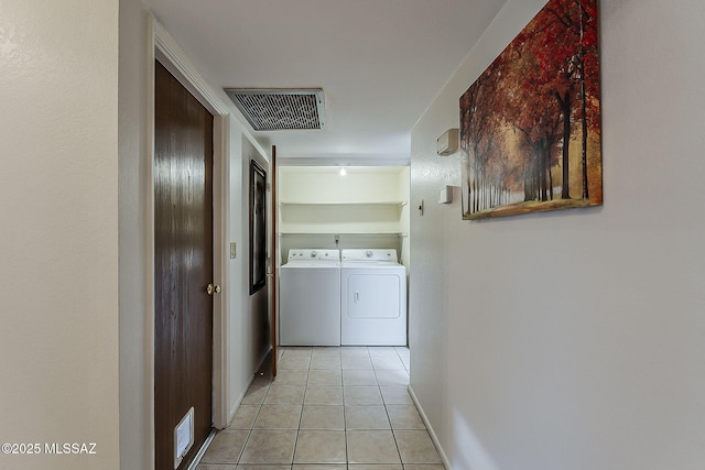 9453 E Calle Bolivar, Tucson, AZ 85715 - hallway featuring washer and dryer and light tile patterned floors
