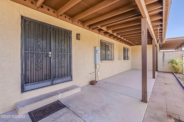 9453 E Calle Bolivar, Tucson, AZ 85715 - view of exterior entry featuring stucco siding and a patio area