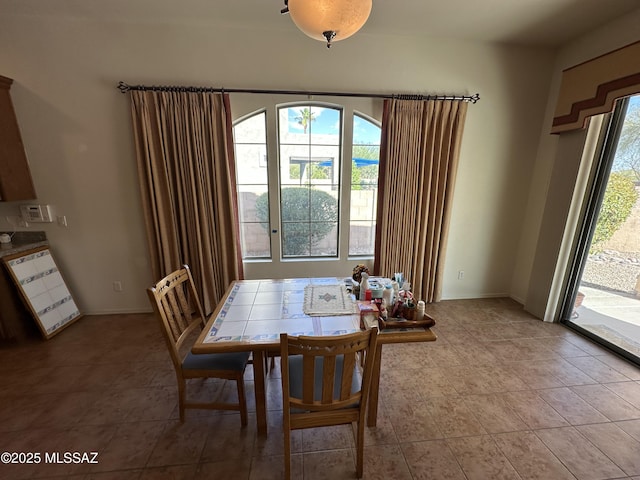13049 N Woosnam Way, Oro Valley, AZ 85755 - dining room with light tile patterned floors and baseboards