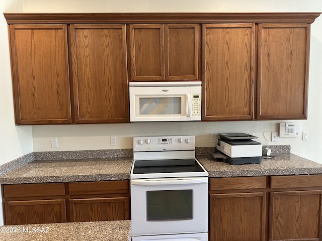 13049 N Woosnam Way, Oro Valley, AZ 85755 - kitchen with white appliances and dark countertops