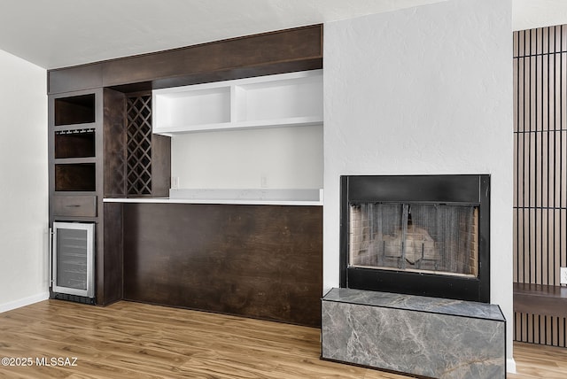 446 Soda Ln, Rio Rico, AZ 85648 - detailed view of beverage cooler, wood finished floors, a fireplace with raised hearth, and a dry bar