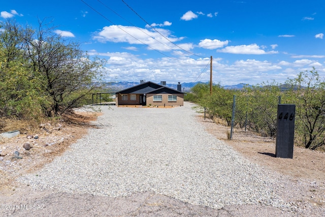 446 Soda Ln, Rio Rico, AZ 85648 - view of front of home with gravel driveway and a mountain view