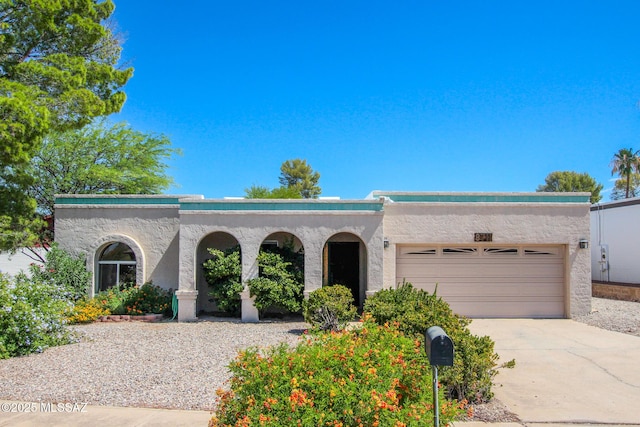 8711 E 28th St, Tucson, AZ 85710 - view of front of home featuring stucco siding, a garage, and concrete driveway