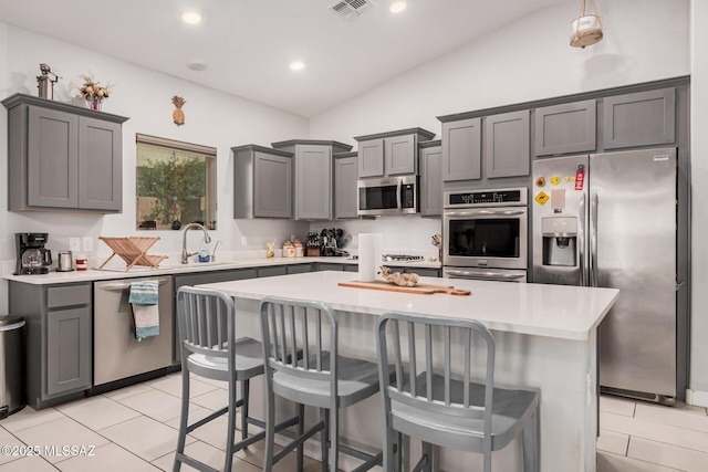 276 W Charles L Mckay St, Vail, AZ 85641 - kitchen featuring stainless steel appliances, vaulted ceiling, light countertops, a kitchen island, and a kitchen breakfast bar