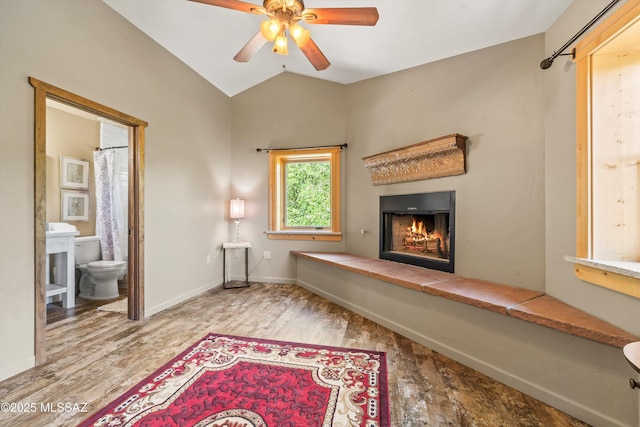 11101 E Miami St, Mount Lemmon, AZ 85619 - unfurnished room with a lit fireplace, wood finished floors, a ceiling fan, and vaulted ceiling