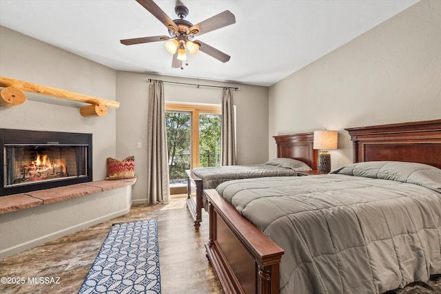 11101 E Miami St, Mount Lemmon, AZ 85619 - bedroom featuring access to outside, a warm lit fireplace, wood finished floors, and a ceiling fan