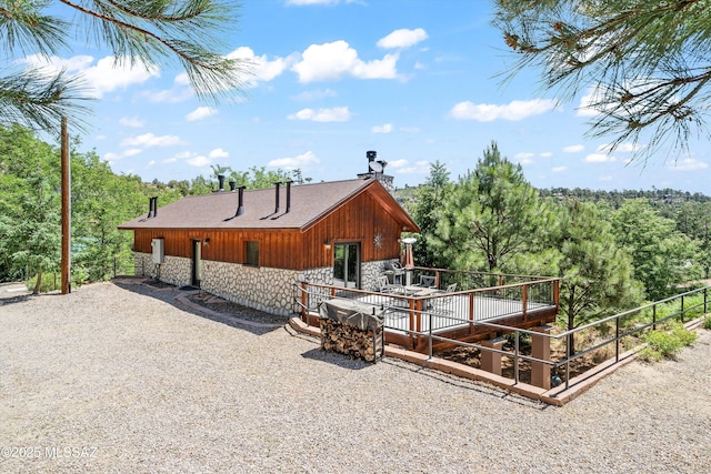 11101 E Miami St, Mount Lemmon, AZ 85619 - back of property featuring stone siding, a wooden deck, and a chimney