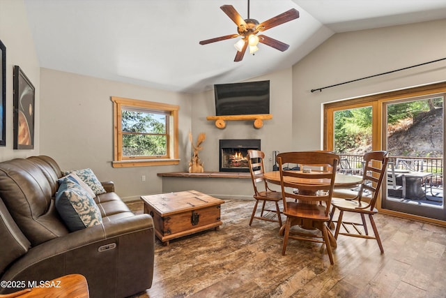 11101 E Miami St, Mount Lemmon, AZ 85619 - living area featuring vaulted ceiling, wood finished floors, healthy amount of natural light, ceiling fan, and a warm lit fireplace