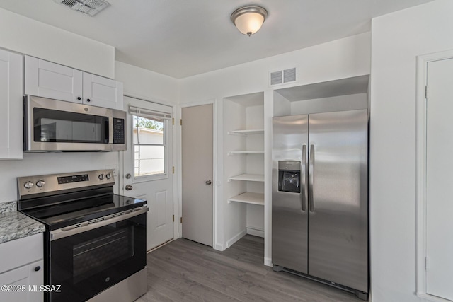 4041 E Dover Stra, Tucson, AZ 85706 - kitchen featuring stainless steel appliances, white cabinetry, light countertops, and wood finished floors