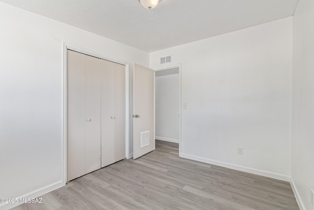 4041 E Dover Stra, Tucson, AZ 85706 - unfurnished bedroom featuring light wood-style floors and a closet