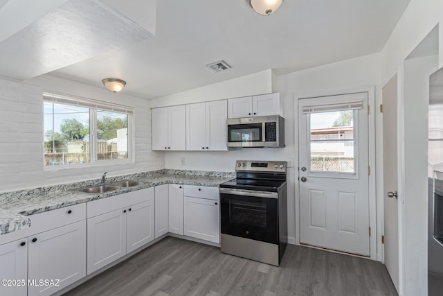 4041 E Dover Stra, Tucson, AZ 85706 - kitchen with stainless steel appliances, light wood-style floors, white cabinets, and light stone countertops