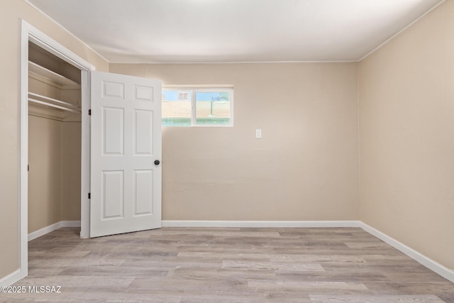 2514 N Castro Ave, Tucson, AZ 85705 - unfurnished bedroom featuring wood finished floors and a closet