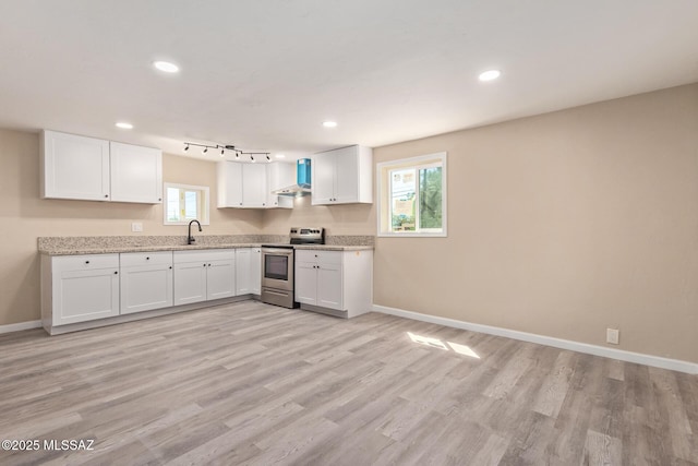 2514 N Castro Ave, Tucson, AZ 85705 - kitchen with stainless steel electric range oven, white cabinets, light wood-style floors, recessed lighting, and light stone countertops