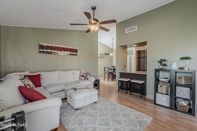 6490 N Tierra De Las Catalinas Unit 94, Tucson, AZ 85718 - living room featuring wood finished floors, ceiling fan, and high vaulted ceiling