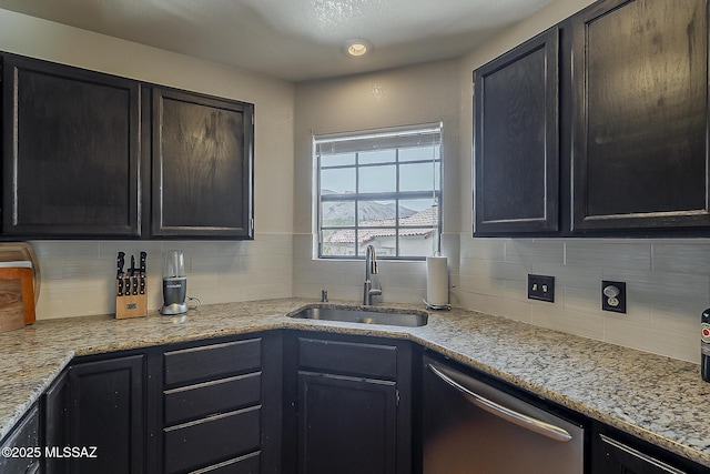 6490 N Tierra De Las Catalinas Unit 94, Tucson, AZ 85718 - kitchen featuring dishwasher, tasteful backsplash, light stone countertops, and dark cabinets