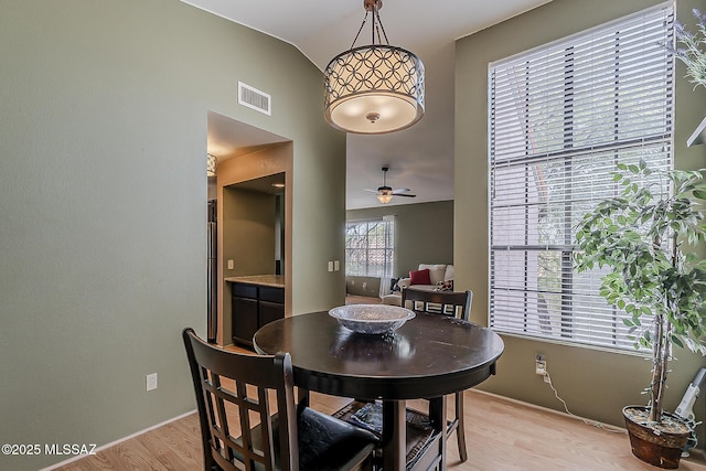 6490 N Tierra De Las Catalinas Unit 94, Tucson, AZ 85718 - dining area featuring light wood-style flooring, ceiling fan, and lofted ceiling