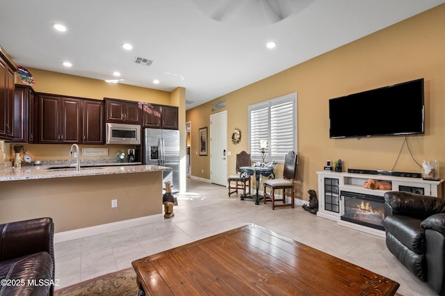14326 Whitehorn Pl, Marana, AZ 85658 - living room featuring a glass covered fireplace, recessed lighting, a ceiling fan, and light tile patterned floors