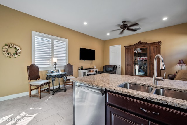 14326 Whitehorn Pl, Marana, AZ 85658 - kitchen with stainless steel dishwasher, ceiling fan, light stone counters, open floor plan, and recessed lighting