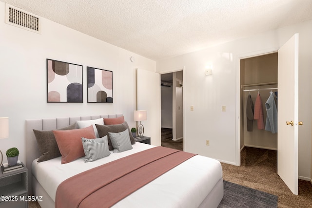 6635 E Golf Links Rd Apt 1, Tucson, AZ 85730 - carpeted bedroom featuring a spacious closet, a textured ceiling, and a closet