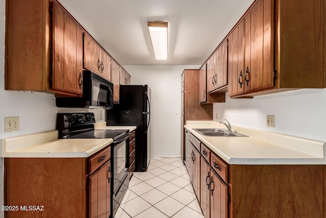 6635 E Golf Links Rd Apt 1, Tucson, AZ 85730 - kitchen featuring black appliances, light countertops, light tile patterned floors, and brown cabinetry