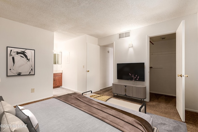 6635 E Golf Links Rd Apt 1, Tucson, AZ 85730 - carpeted bedroom featuring ensuite bath and a textured ceiling