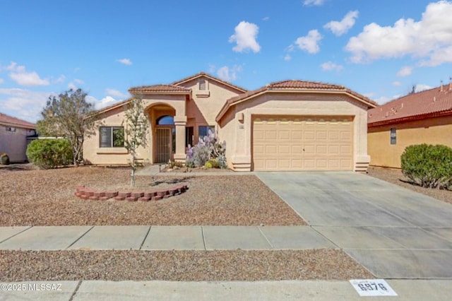 6976 Somerton Dr, Tucson, AZ 85743 - mediterranean / spanish house with an attached garage, stucco siding, driveway, and a tile roof