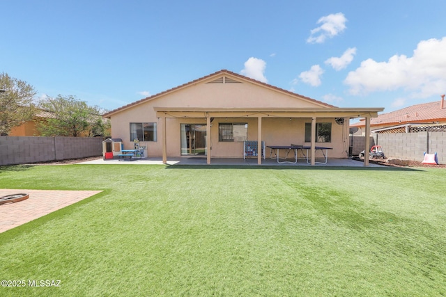 6976 Somerton Dr, Tucson, AZ 85743 - back of property featuring a fenced backyard, a patio, and stucco siding