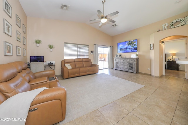 6976 Somerton Dr, Tucson, AZ 85743 - living area featuring a ceiling fan, light tile patterned floors, vaulted ceiling, and arched walkways
