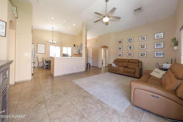 6976 Somerton Dr, Tucson, AZ 85743 - living room with a ceiling fan, arched walkways, light tile patterned floors, high vaulted ceiling, and a chandelier