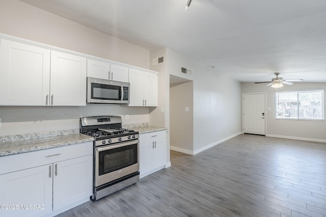 18 E Mac Iver Pl, Tucson, AZ 85705 - kitchen featuring stainless steel appliances, a ceiling fan, white cabinets, light wood-type flooring, and open floor plan