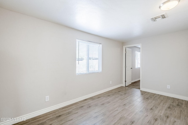 18 E Mac Iver Pl, Tucson, AZ 85705 - empty room featuring wood finished floors and baseboards