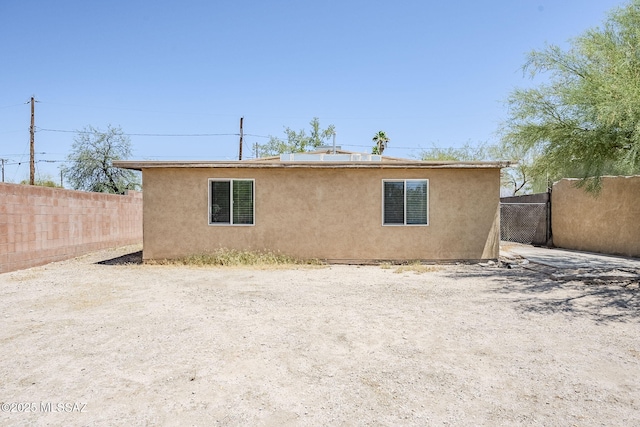 18 E Mac Iver Pl, Tucson, AZ 85705 - rear view of house with stucco siding