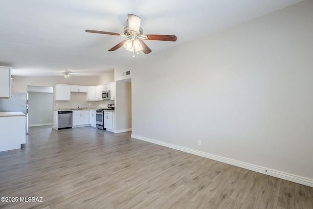 18 E Mac Iver Pl, Tucson, AZ 85705 - unfurnished living room featuring ceiling fan and light wood-style flooring