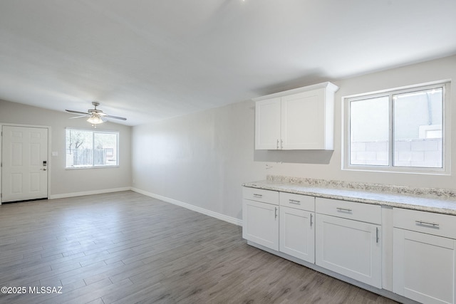 18 E Mac Iver Pl, Tucson, AZ 85705 - kitchen with a ceiling fan, light wood-style flooring, and white cabinets