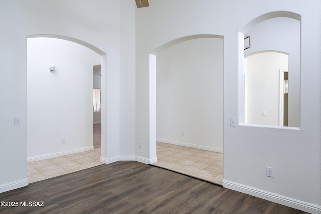 9438 N Weather Hill Dr, Tucson, AZ 85743 - spare room with wood finished floors and arched walkways