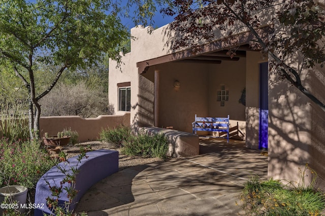 10380 E Rancho Del Este Dr, Tucson, AZ 85749 - doorway to property featuring a patio area and stucco siding