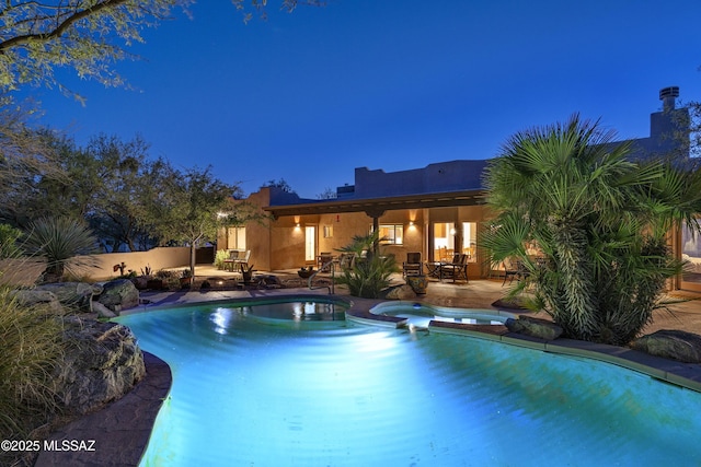 10380 E Rancho Del Este Dr, Tucson, AZ 85749 - pool at night with a patio area and a pool with connected hot tub