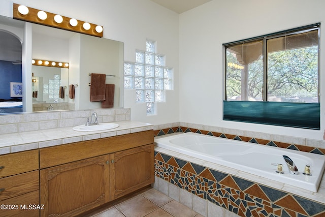 10380 E Rancho Del Este Dr, Tucson, AZ 85749 - ensuite bathroom featuring a garden tub, vanity, healthy amount of natural light, and tile patterned floors