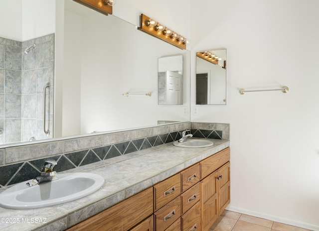 10380 E Rancho Del Este Dr, Tucson, AZ 85749 - full bath featuring double vanity, tile patterned floors, decorative backsplash, and tiled shower