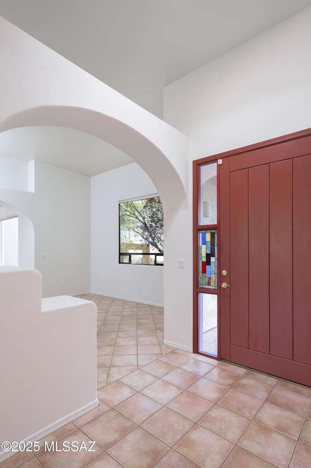 10380 E Rancho Del Este Dr, Tucson, AZ 85749 - entrance foyer featuring light tile patterned flooring and arched walkways