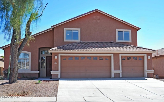 5553 W Carriage Dr, Tucson, AZ 85742 - mediterranean / spanish home featuring driveway, stucco siding, a tile roof, and a garage