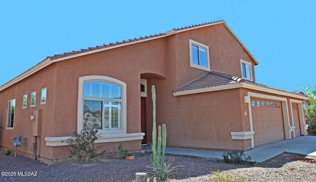 5553 W Carriage Dr, Tucson, AZ 85742 - mediterranean / spanish-style house with stucco siding, a tile roof, a garage, and driveway