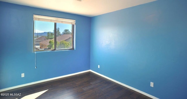 5553 W Carriage Dr, Tucson, AZ 85742 - empty room featuring baseboards and dark wood finished floors