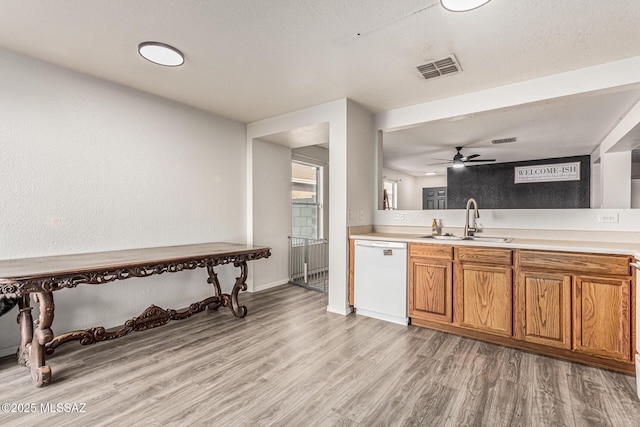 6293 S Sun View Way, Tucson, AZ 85706 - kitchen with dishwasher, light wood-style floors, brown cabinetry, and light countertops