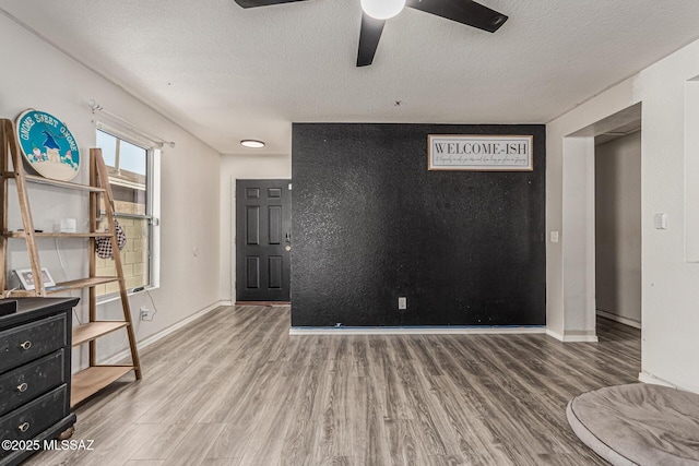 6293 S Sun View Way, Tucson, AZ 85706 - unfurnished bedroom with wood finished floors, a textured ceiling, and a ceiling fan